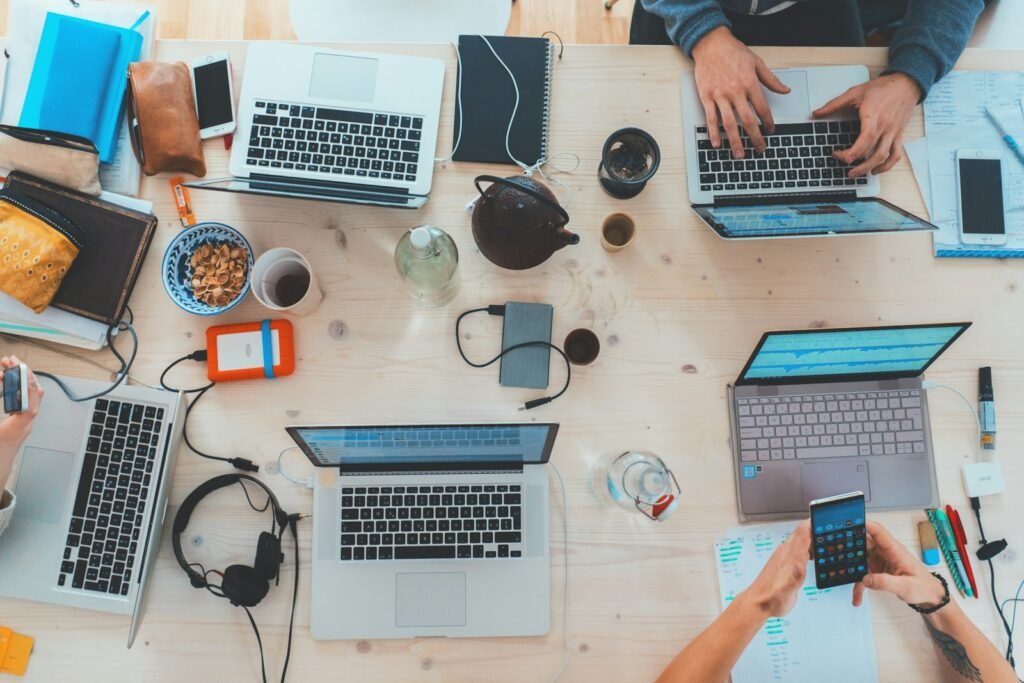 Team working across laptops and phones